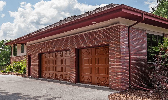 Front of brick home with two red garage doors